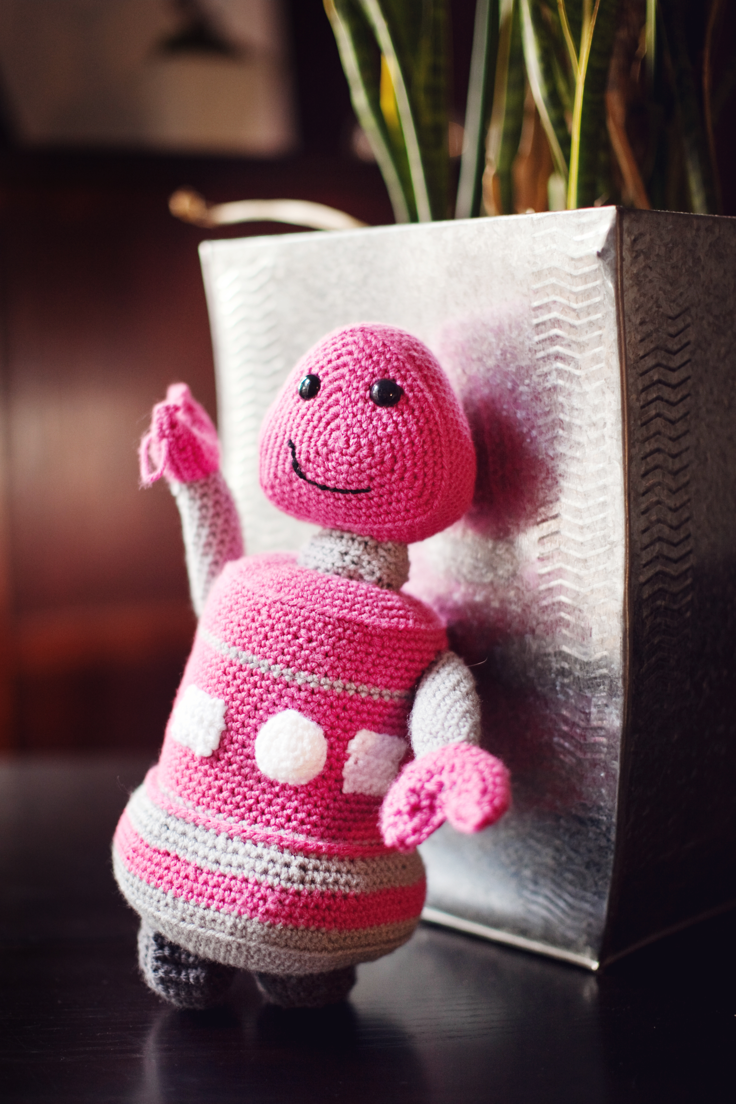 Crocheted pink robot plush